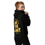 Woman Wearing A Black Be The Light Hoodie