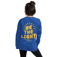 Woman Wearing A Royal Blue Be The Light Sweatshirt